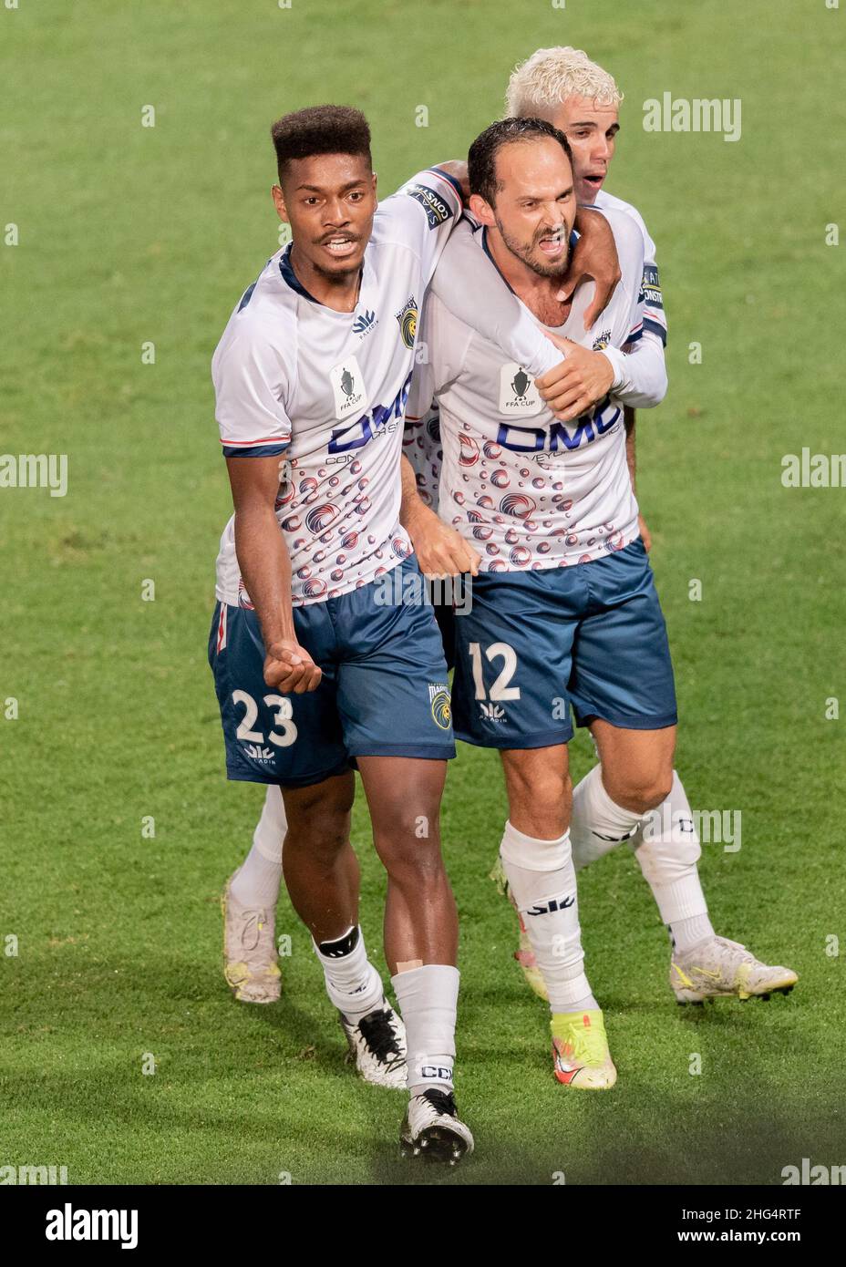 Marcos Urena (12) of the Mariners celebrates with Daniel Hall (23) after scoring a goal during the FFA Cup 2021 Semi Final match between Sydney FC and Central Coast Mariners at Netstrata Jubilee Stadium on January 18, 2022, in Sydney, Australia. (Editorial use only) Stock Photo