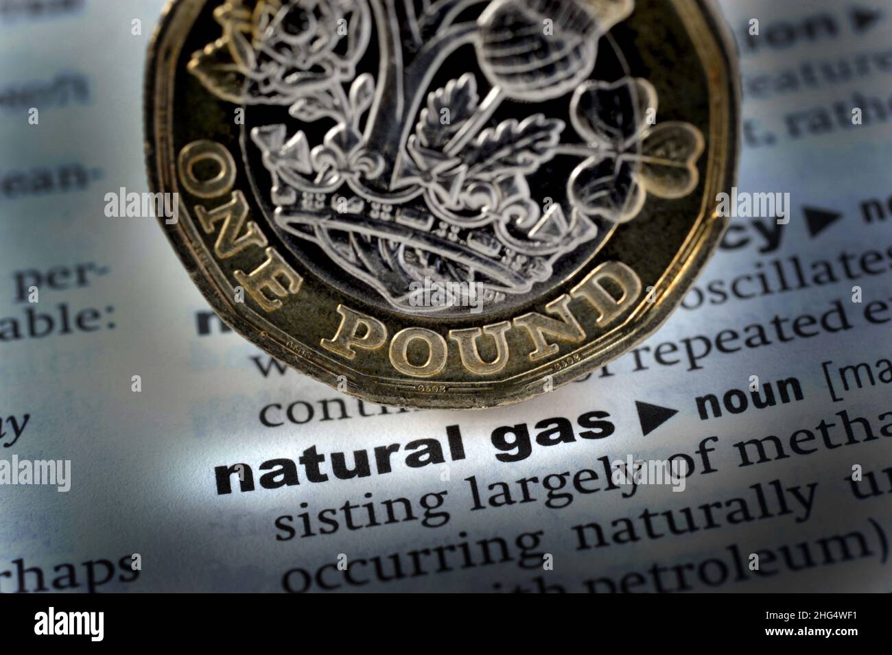 DICTIONARY DEFINITION OF OF WORDS NATURAL GAS WITH ONE POUND COIN RE ENERGY PRICES HEATING COST OF LIVING FOSSIL FUELS ETC UK Stock Photo