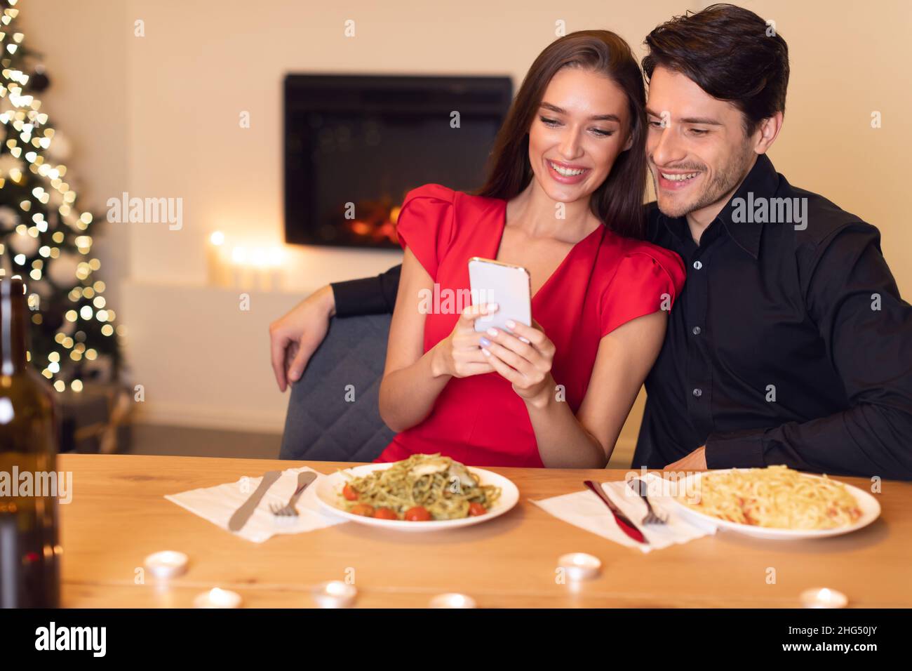 Couple looking smartphone together meal hi-res stock photography and ...