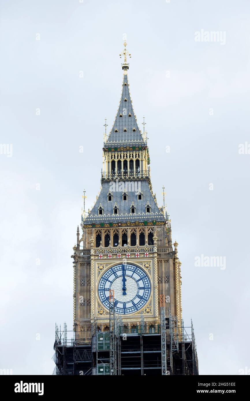 A clock face shows midday on Elizabeth Tower or Big Ben in Westminster, central London, on News Year’s Eve. Stock Photo