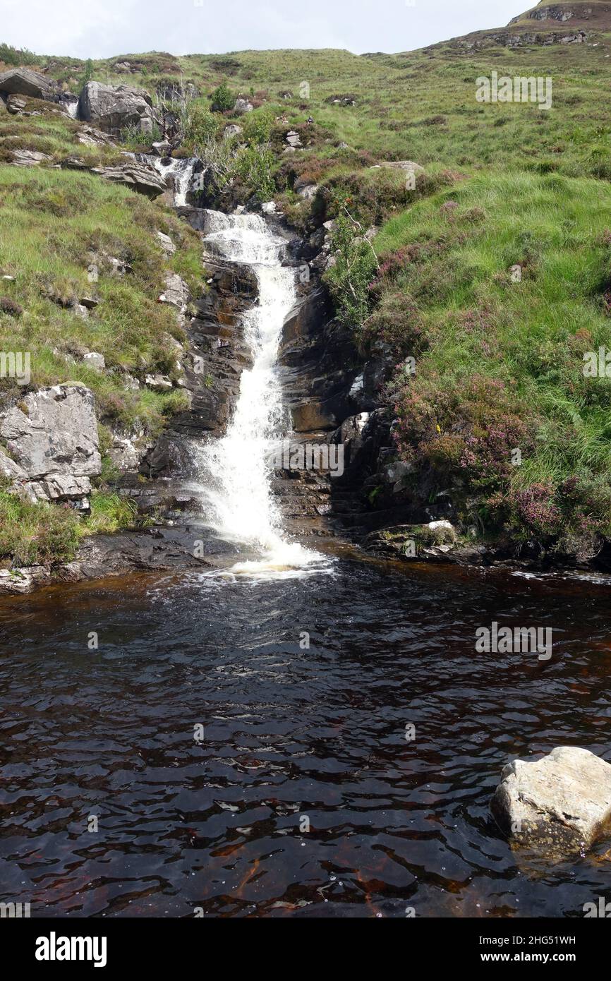 Waterfall Flowing into Plunge Pool by the Path to the Scottish Mountain Munro 'Ben Hope' in Strathmore, Sutherland, Scottish Highlands, Scotland, UK. Stock Photo