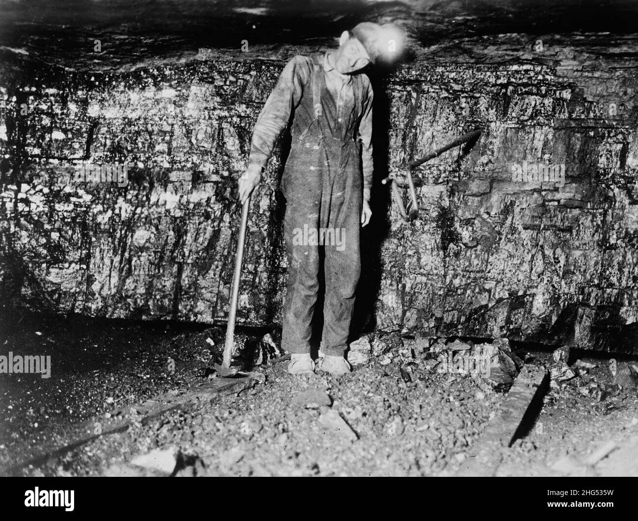 Coal miner in an American coal mine circa 1910 showing the dirty and cramped conditions they worked in Stock Photo