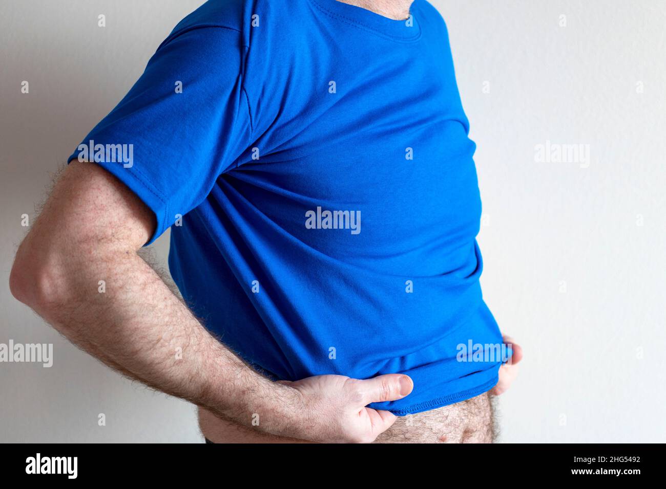 Man dresses, tries on a Tshirt. man wearing tshirt and jeans