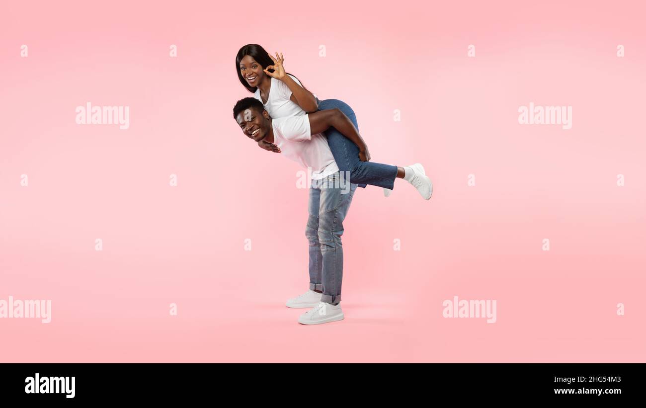Happy black couple gesturing okay and having fun Stock Photo