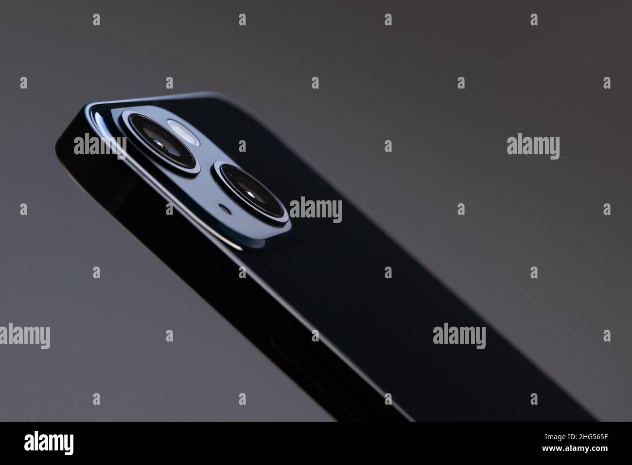 black glossy modern rectangular smartphone with two large cameras close-up on a gray isolated background Stock Photo