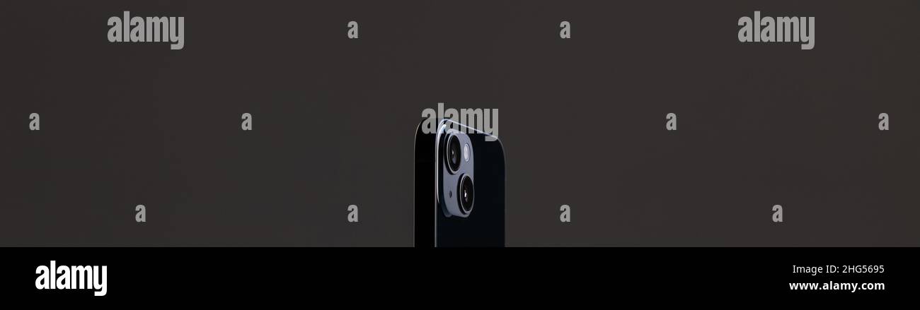 black modern smartphone with rectangular edges and two cameras on a gray background Stock Photo