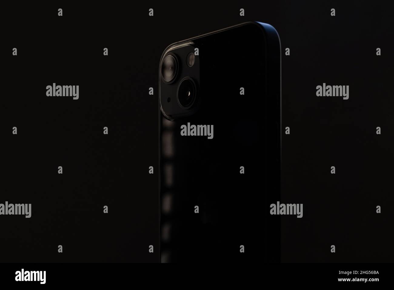 stylish glossy rectangular smartphone with two cameras on a black isolated background close-up. Stock Photo