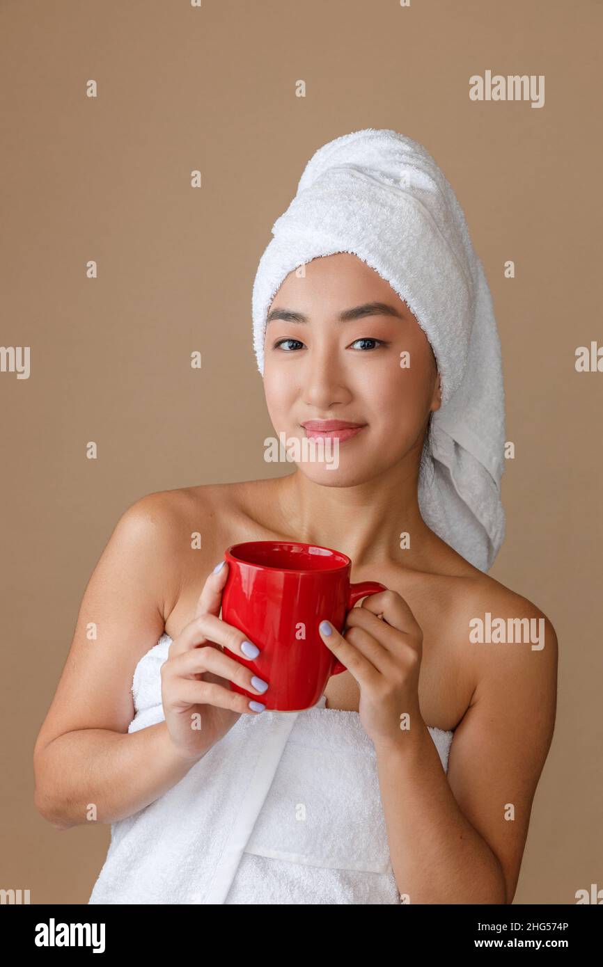Asian young woman drinking coffee after shower Stock Photo Alamy