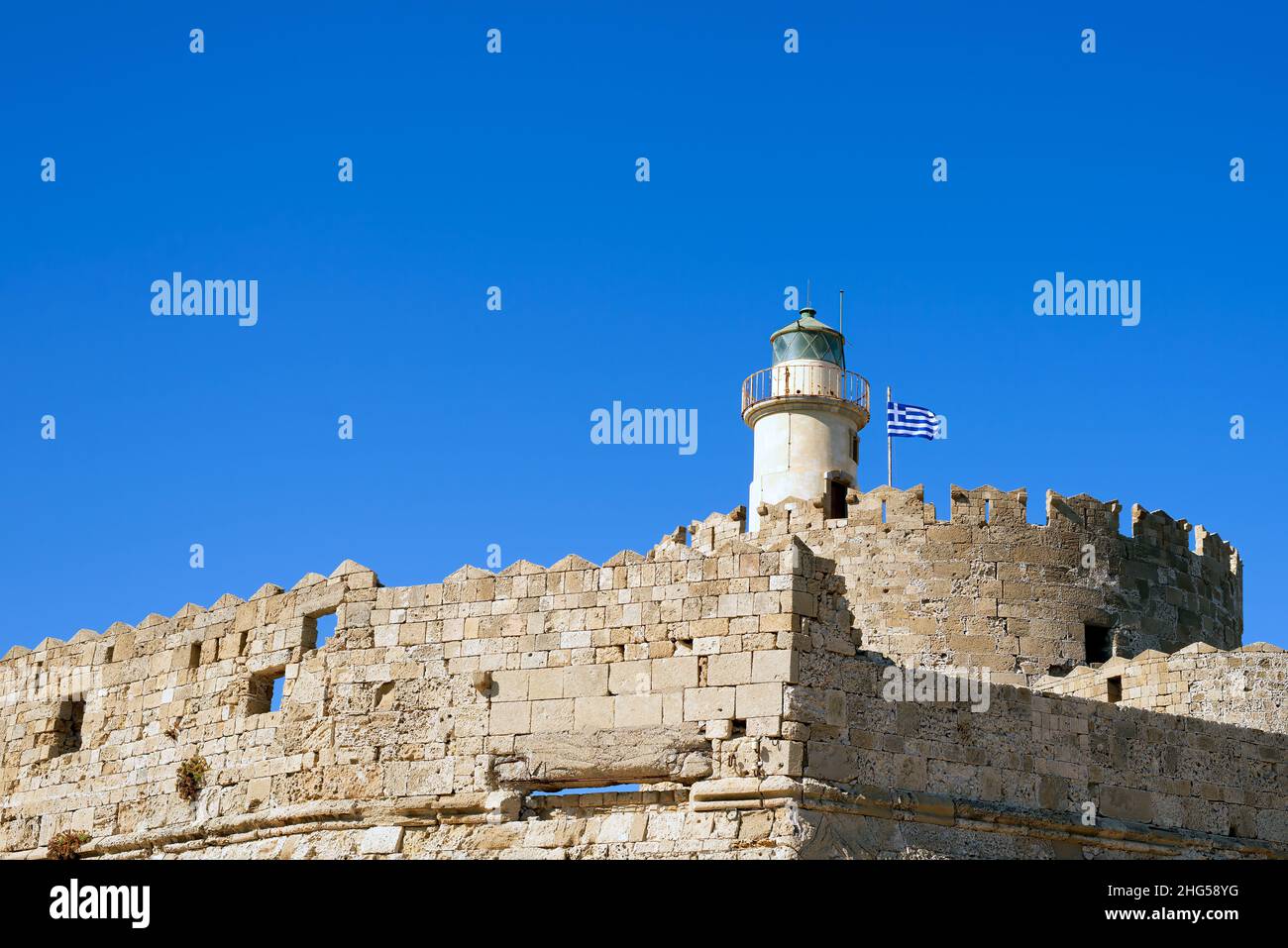 Agios Nikolaos lighthouse in Rhodes Mandraki harbour on riuns of ...