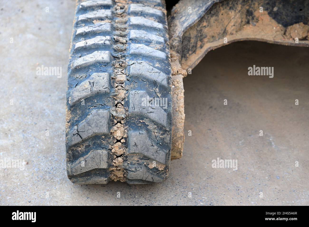 close-up used and dirty Rubber caterpillar bulldozer. Close up Excavator crawler belt in construction site Stock Photo