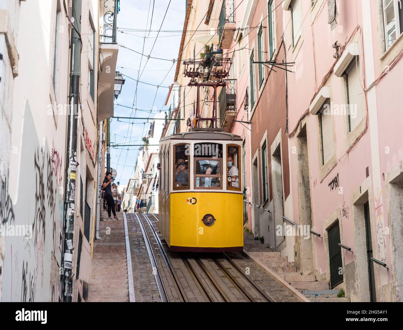 A cablecar of Lisbon's Elevador da Bica that connects the city's Bairro Alto with the Chiado quarter below. Stock Photo