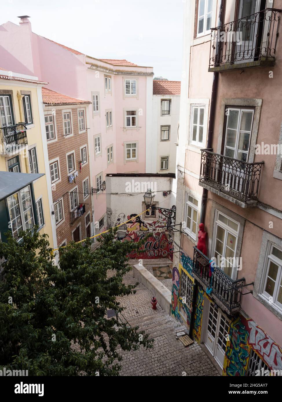 Lisbon, Portugal - 18 October 2021: Narrow street in Lisbon's historic Alfama quarter Stock Photo