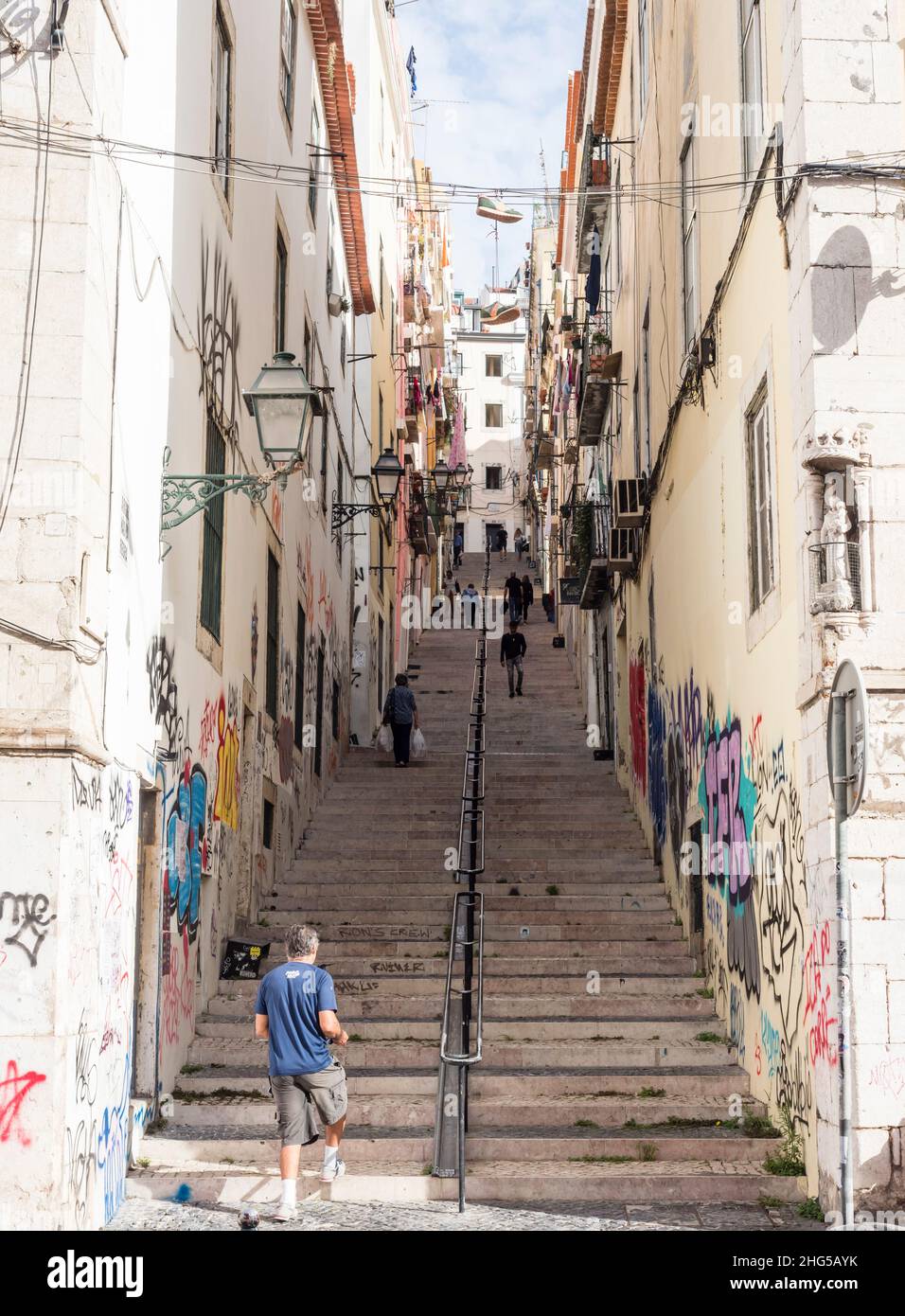 Lisbon, Portugal - 21 October 2021: Stairways on a steep street that connects the Lisbon's Bairro Alto with the Chiado quarter below. Stock Photo