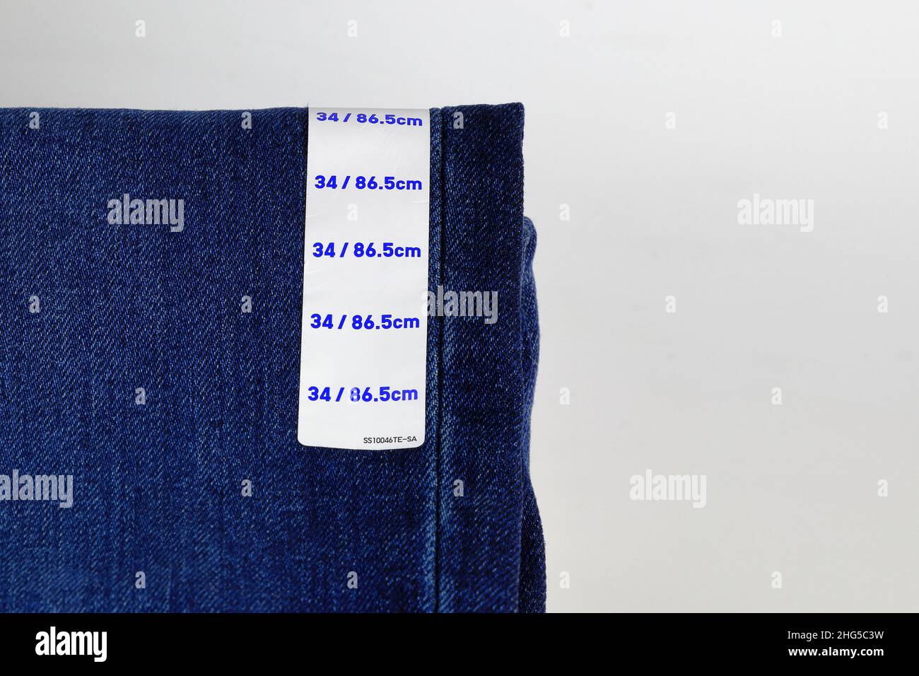 Blue jeans denim with label size, collection jeans stacked with label size, size tag on Blue jeans denim pants. Stock Photo