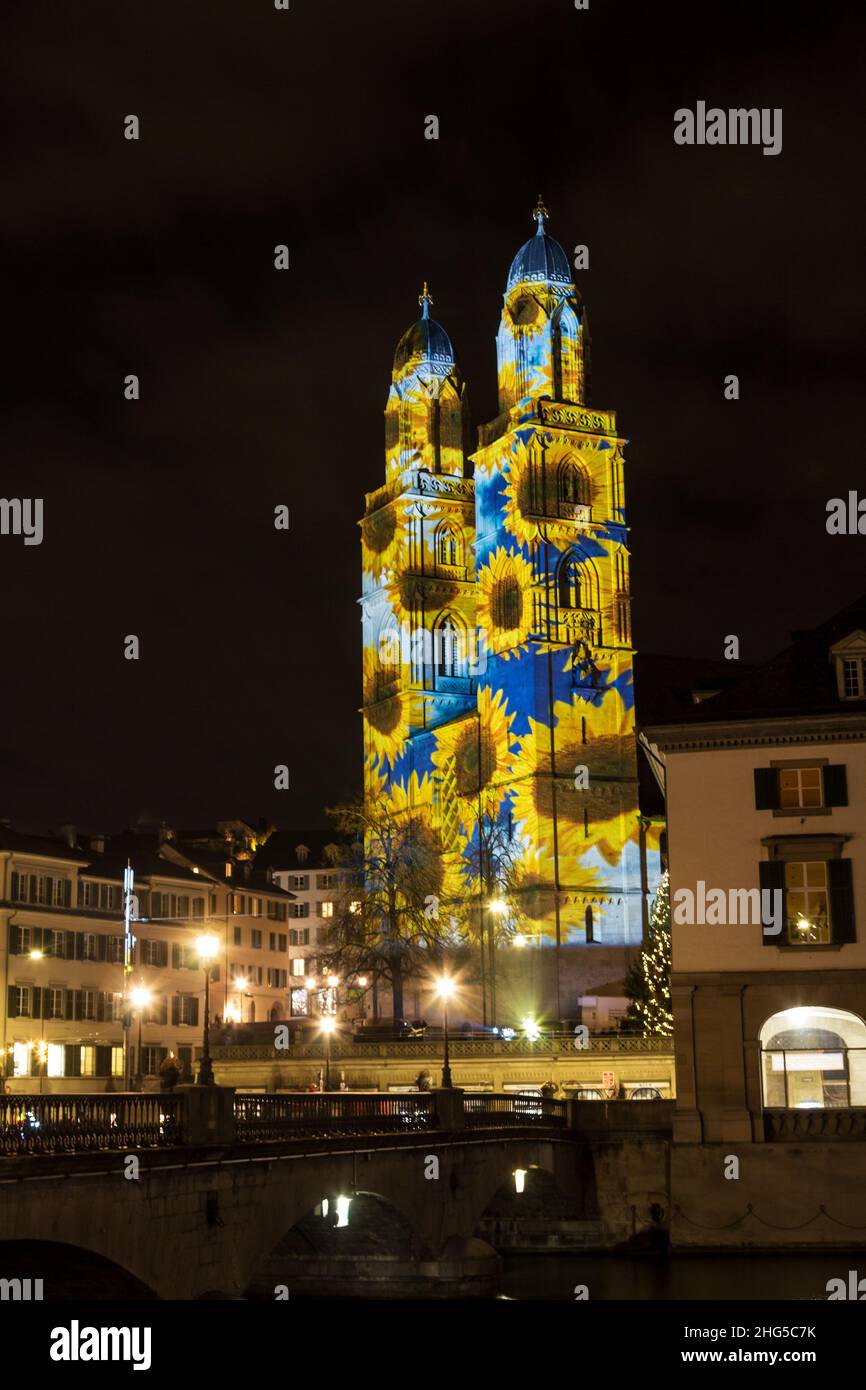 Zurich, Switzerland - 02. January 2022: The new year light show in down town Zurich with beautiful graphic  sunflower patterns projected on the church Stock Photo