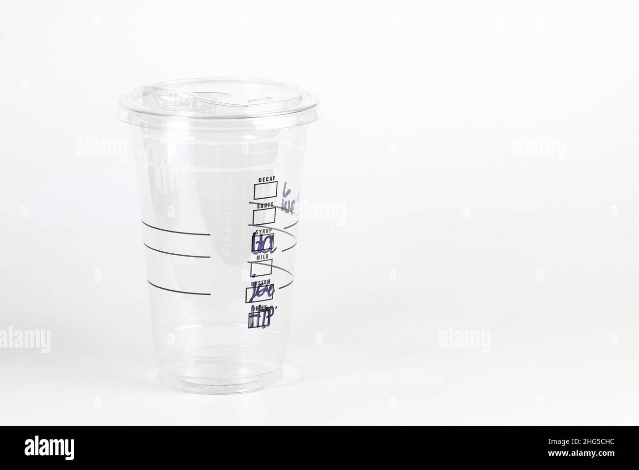 Real empty Plastic clear cup with flat lid and checkbox for mark detail on side isolated on white. Stock Photo