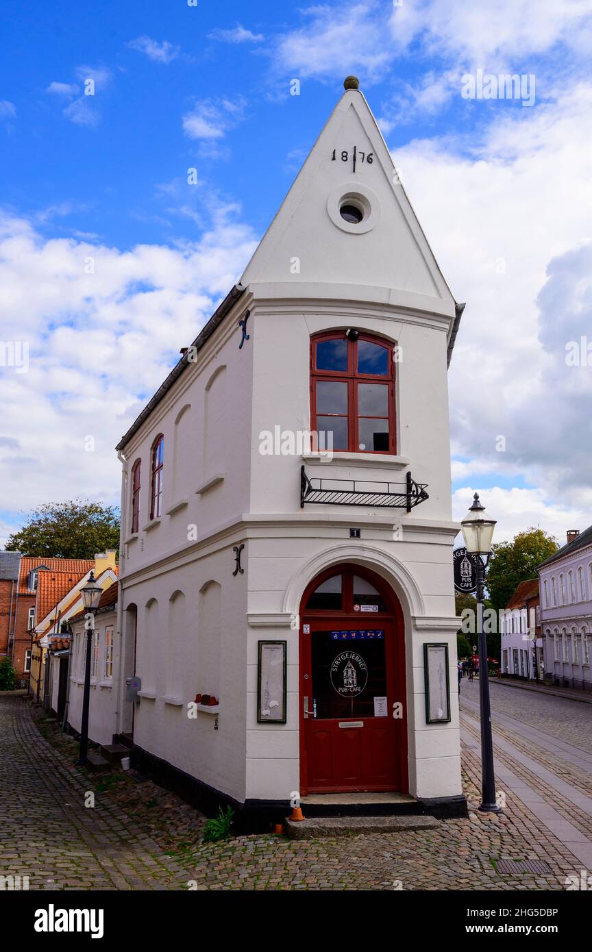 Historical white house on the corner of two merging streets in the town of Ribe, Denmark Stock Photo