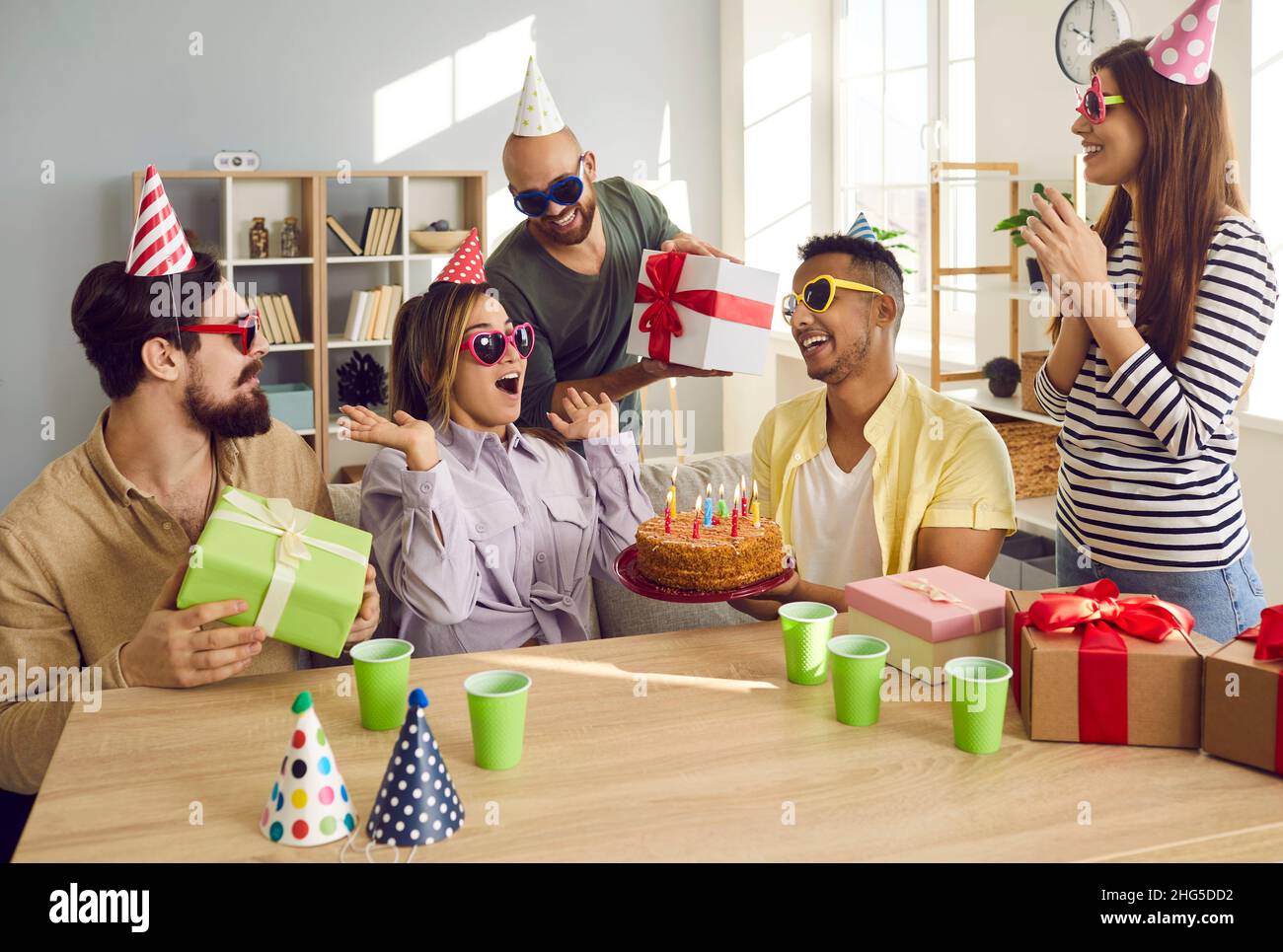 Happy friends celebrate happy birthday with cake Stock Photo