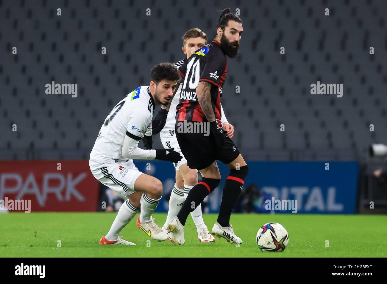 ISTANBUL, TURKEY - JANUARY 18: Oguzhan Ozyakup of Besiktas JK challenges Jakup Jimmy Durmaz of Fatih Karagumruk SK during the Turkish Super Lig match between Fatih Karagümrük SK and Besiktas at Ataturk Olympic Stadium on January 18, 2022 in Istanbul, Turkey (Photo by Orange Pictures) Stock Photo