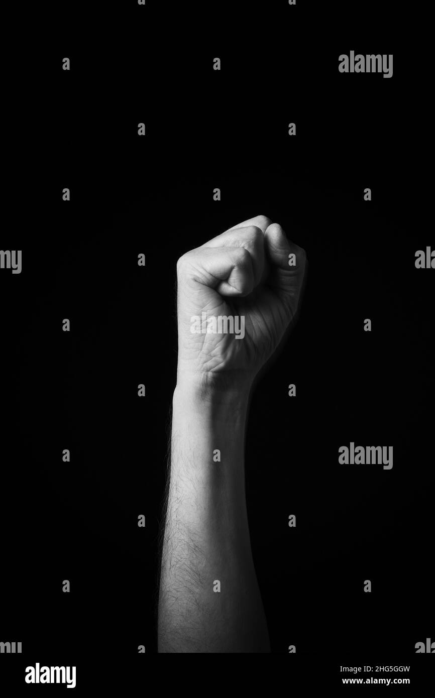 Dramatic B+W image of male hand fingerspelling CSL Chinese sign language letter D isolated against dark background Stock Photo