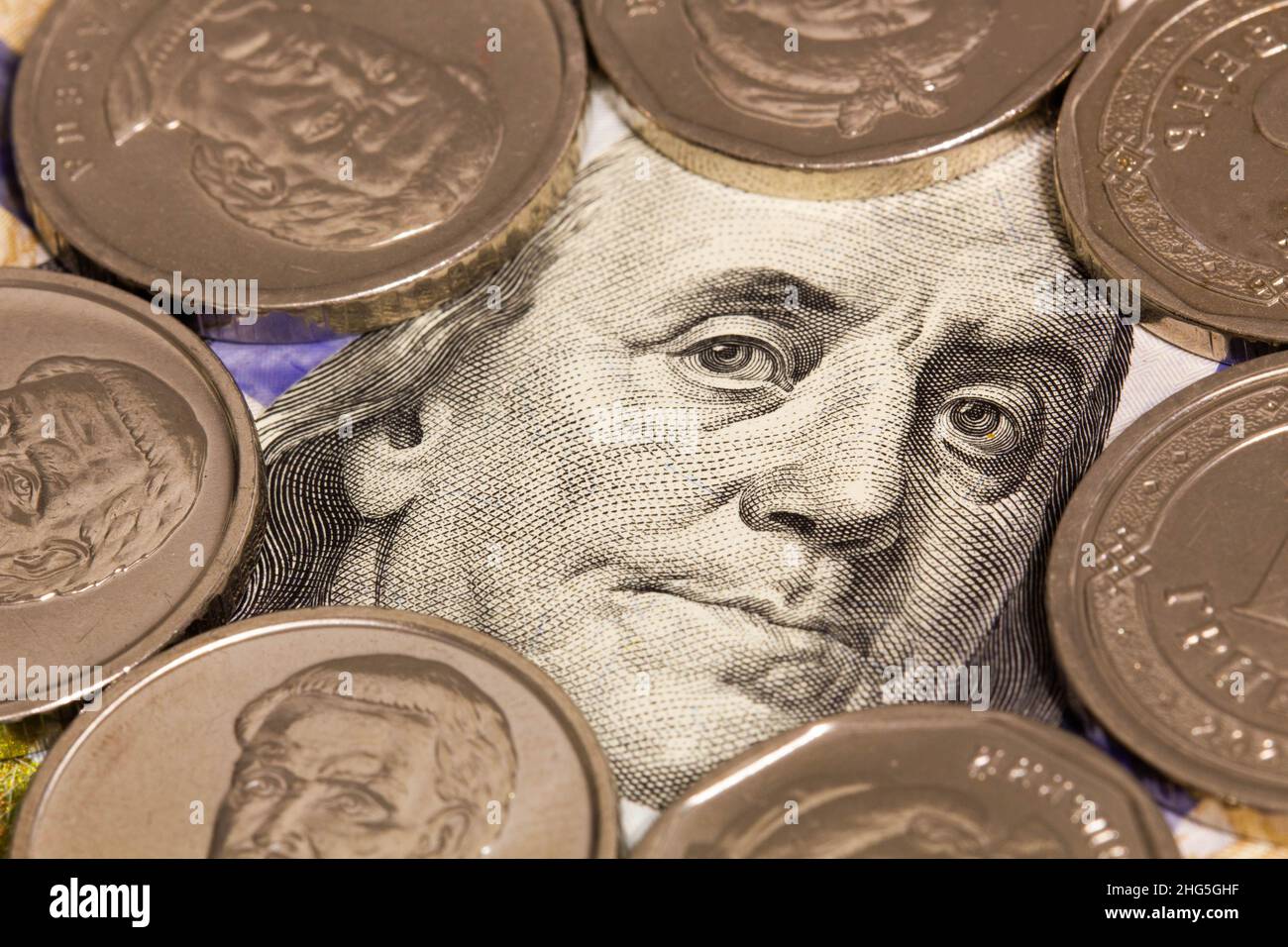 100 dollars banknote and white coins. A portrait of Roosevelt Franklin on a hundred dollar bill framed by silver coins. Money concept for financial Stock Photo