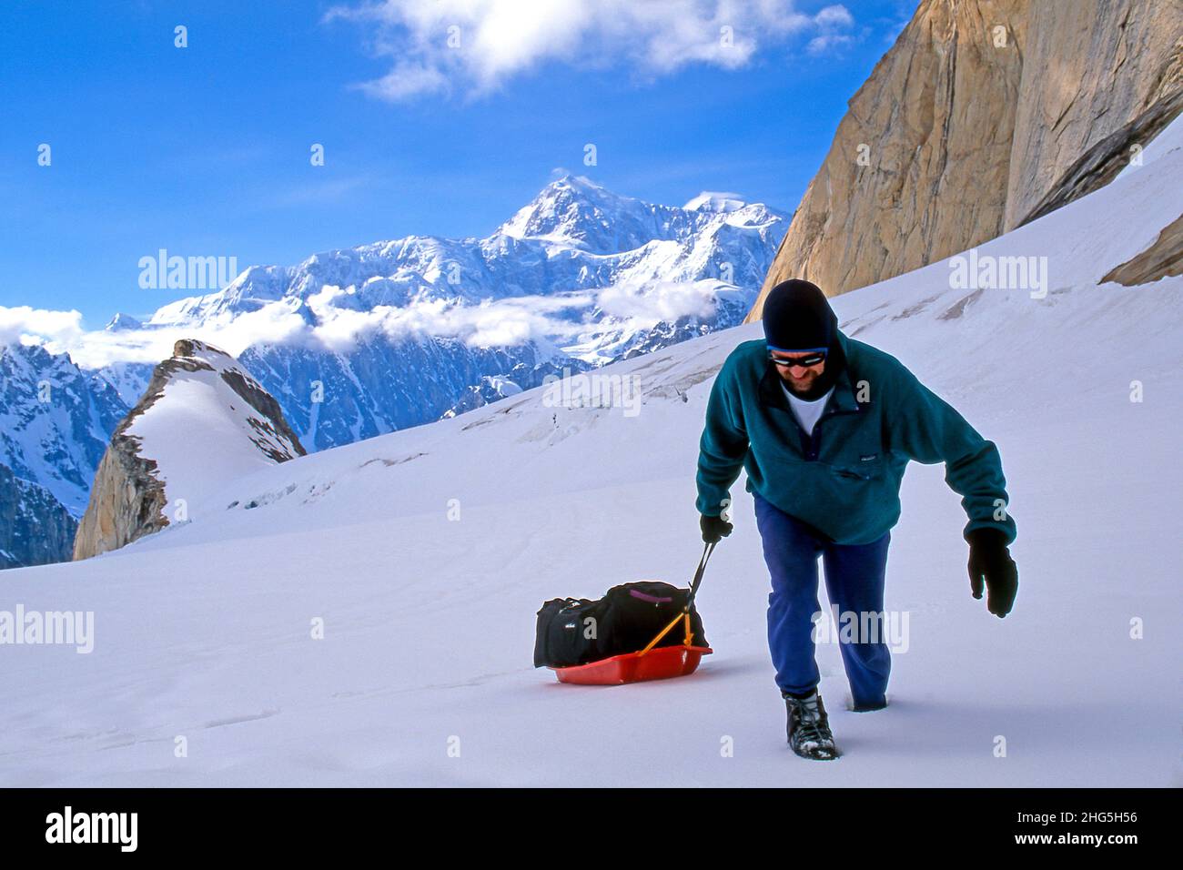 Male mountain climber pulls sled below Moose's tooth in Denali National ...