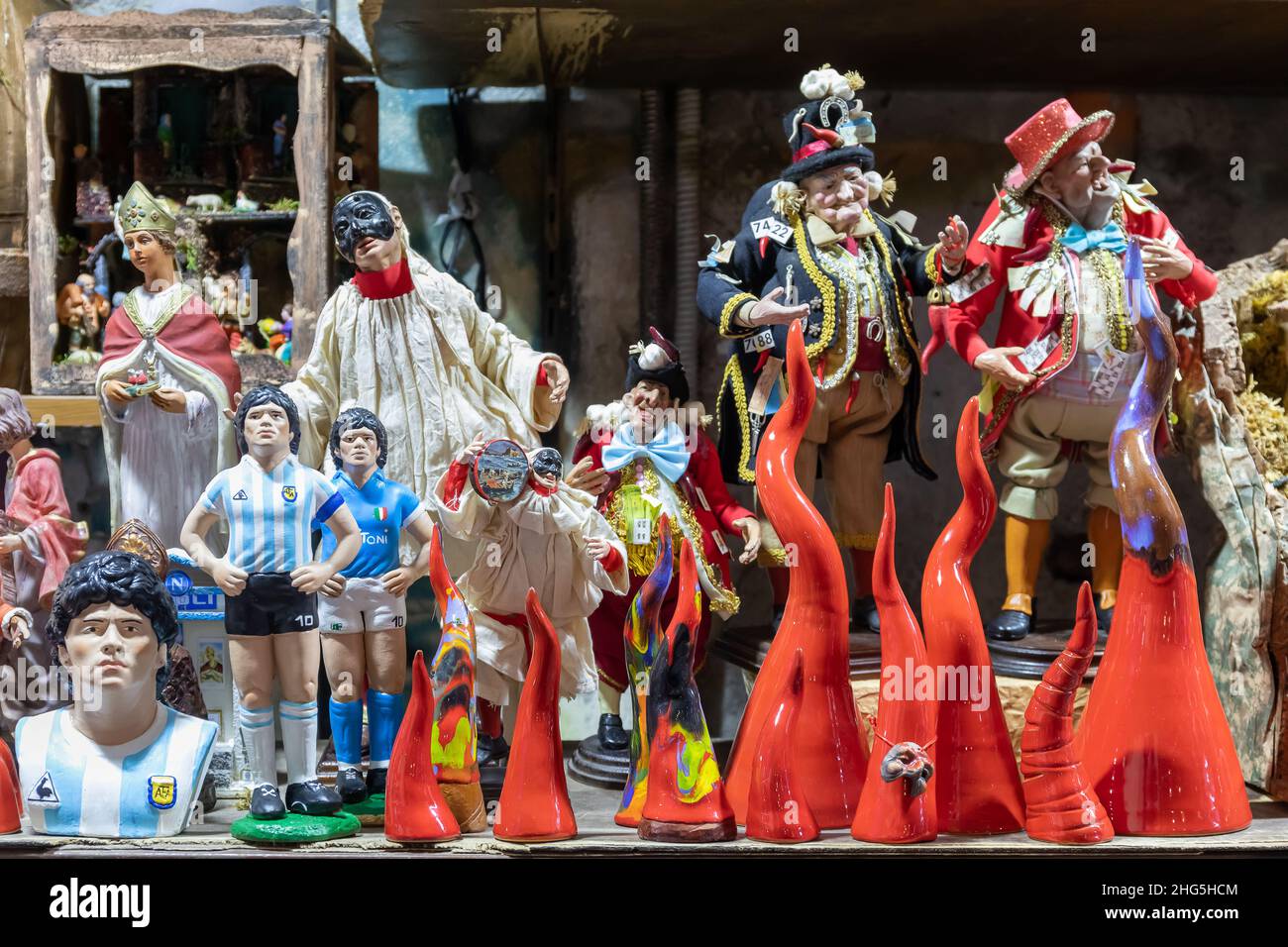 Naples, Italy - December 24, 2021: Hand painted terracotta statuettes, representing famous people, for sale in San Gregorio Armeno, the famous street Stock Photo