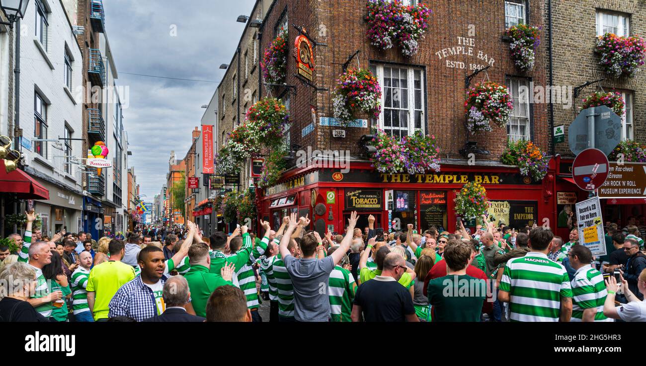 Group of Celtic Football Club fans celebrating outside the famous Dublin pub The Temple Bar. Stock Photo
