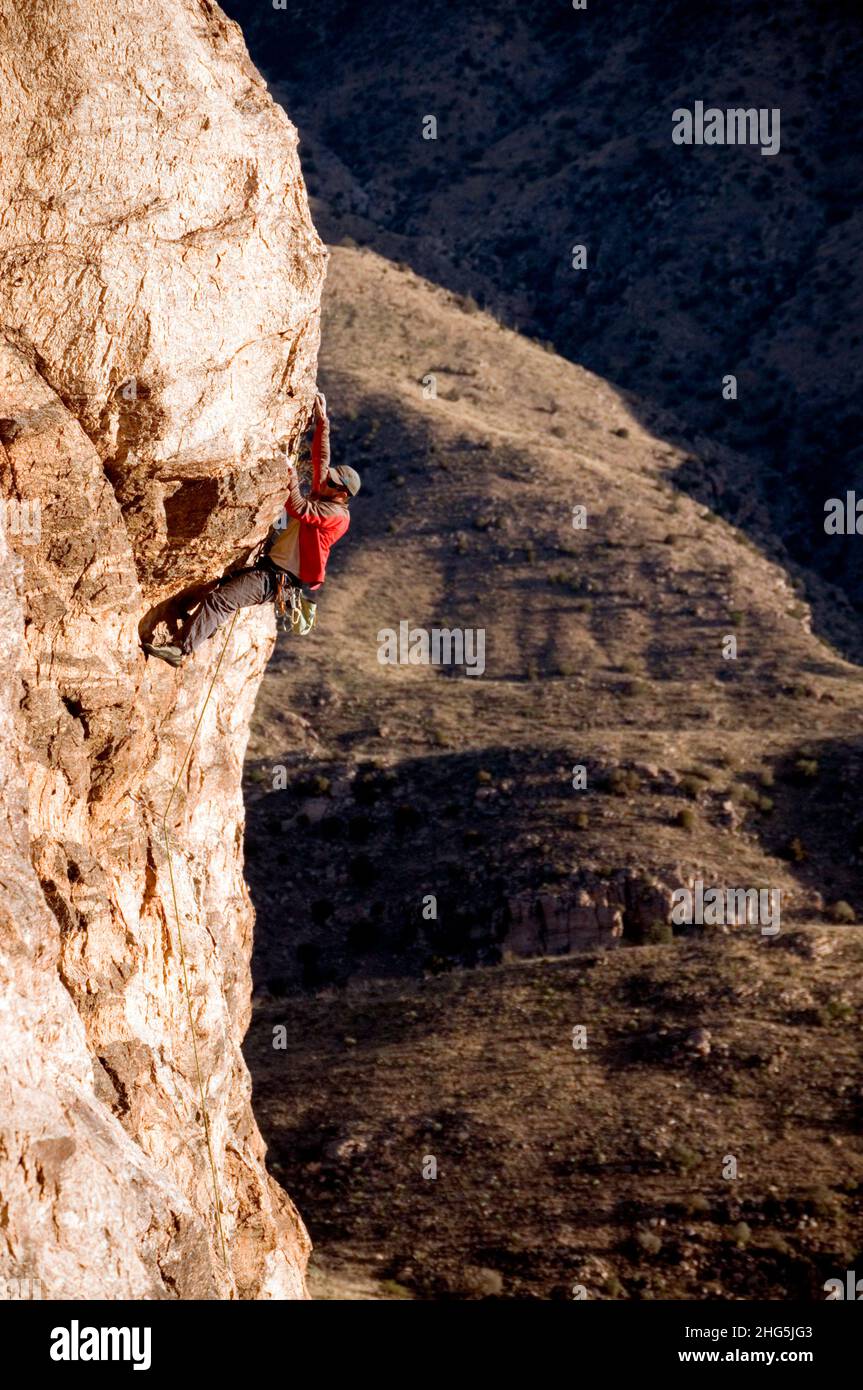Male rock climber struggles on very steep rock. Santa Catalina Mountains, Arizona Stock Photo