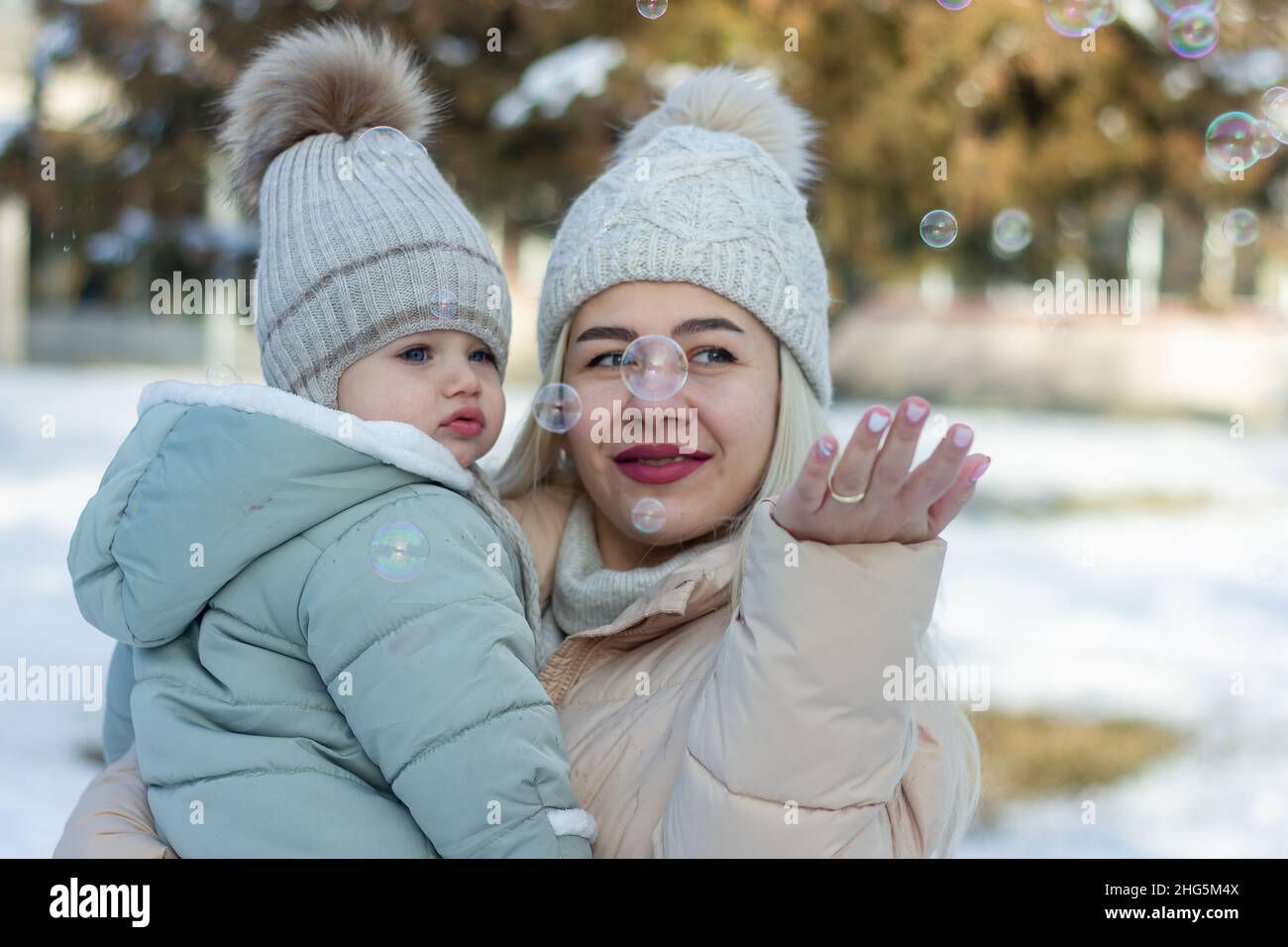 mother and baby boy in winter, parent and child in winter Stock Photo