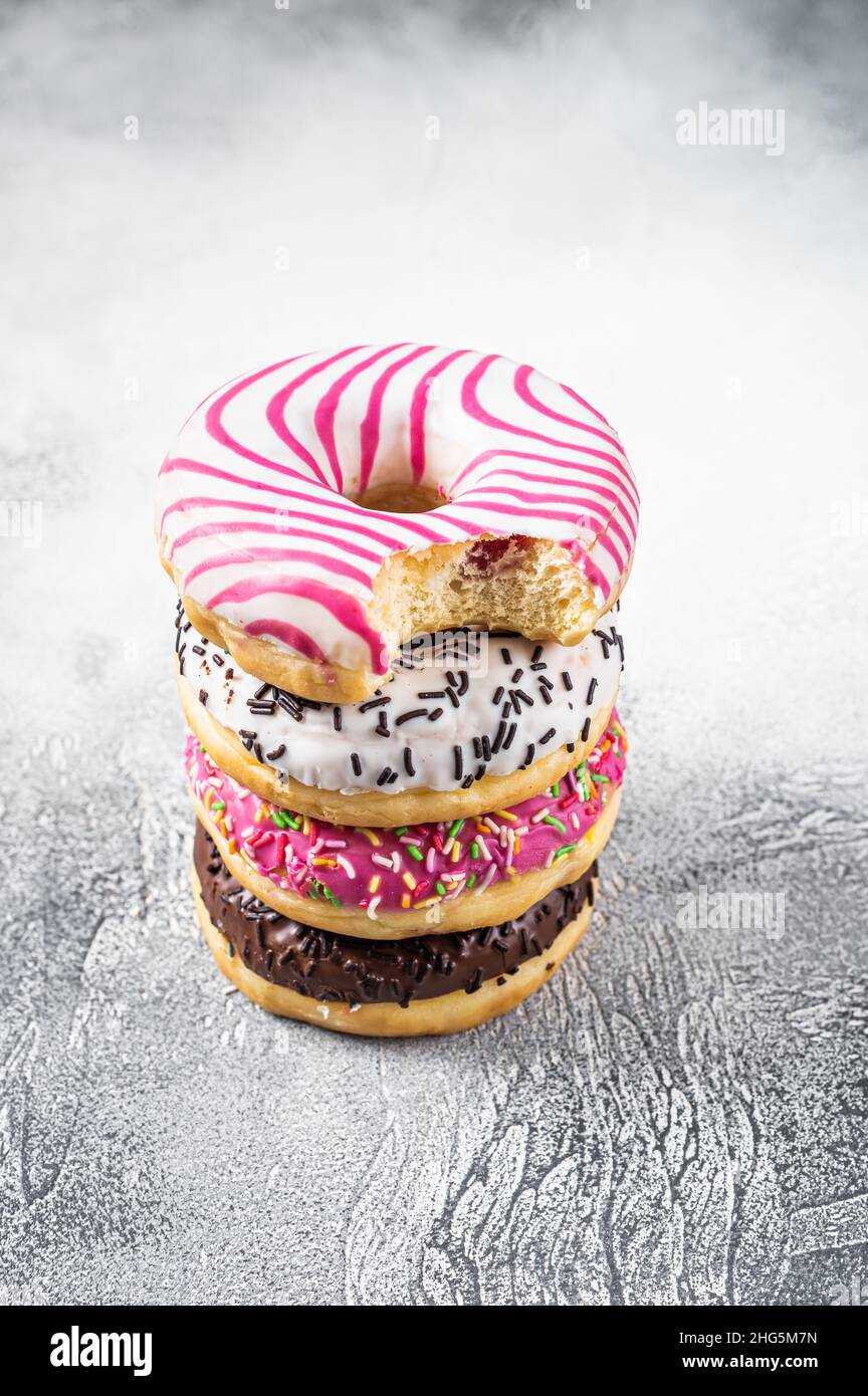 Stack of artisan donuts. White background. Top view. Copy space Stock Photo