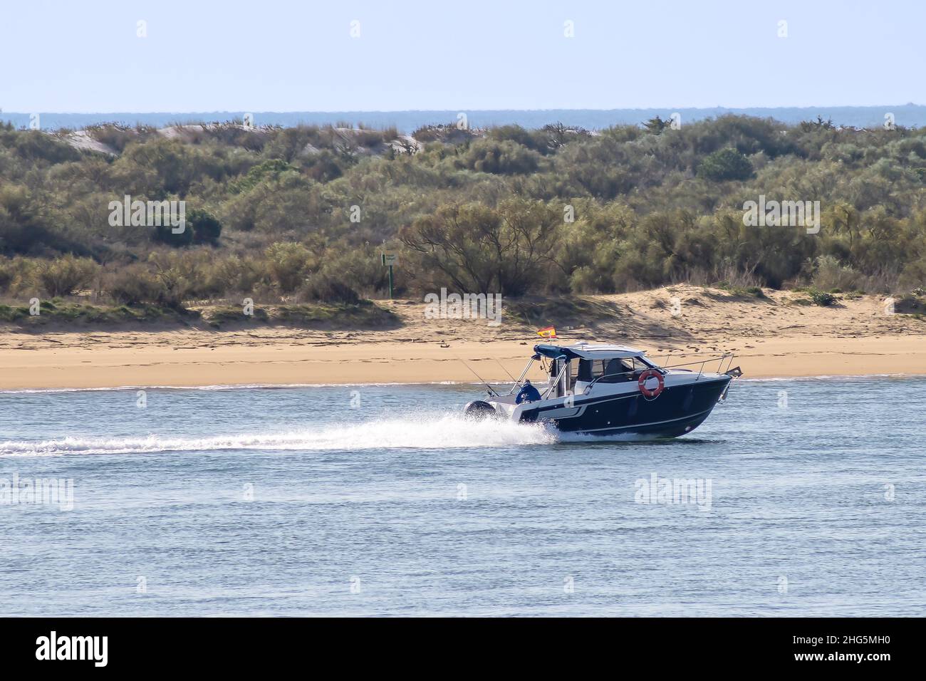 Motor speed boat navigating the bay of El Portil beach in Punta Umbría, Huelva. Stock Photo