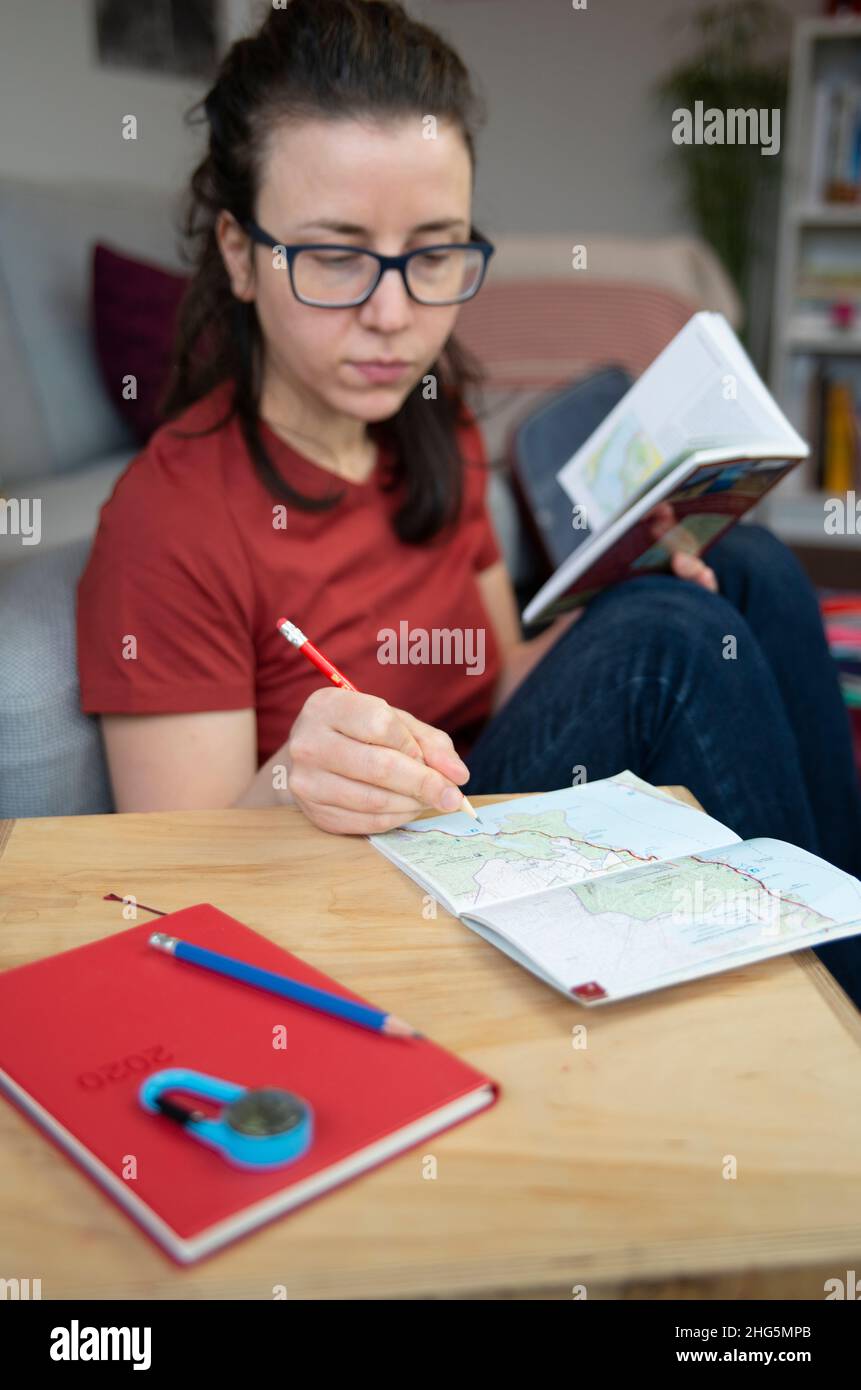 Person planning a trip with a map and a guidebook Stock Photo