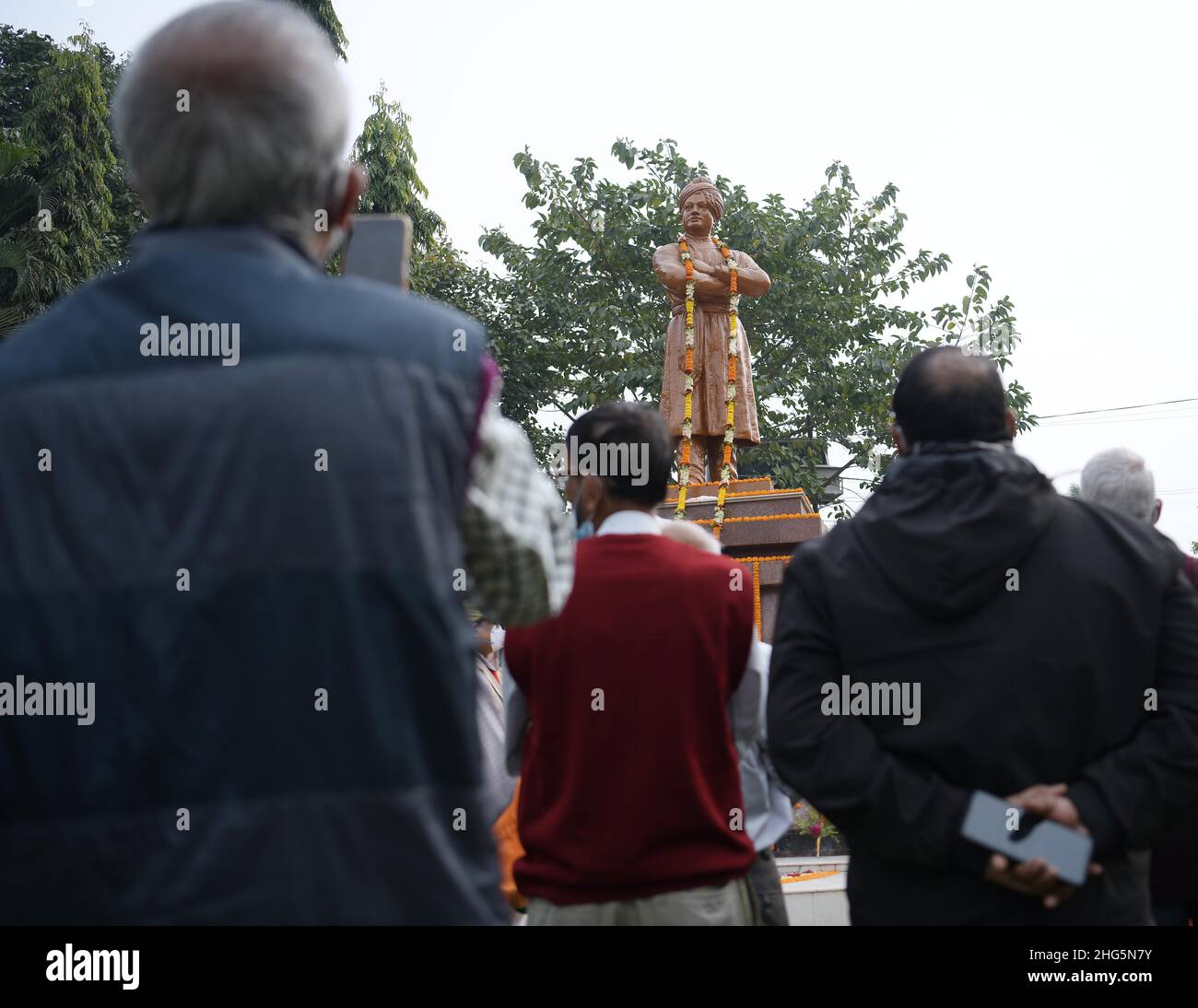 People gathered in front of the statue of Swami Vivekananda during celebration of Vivekananda’s 159th birth anniversary at Agartala. Tripura, India. Stock Photo