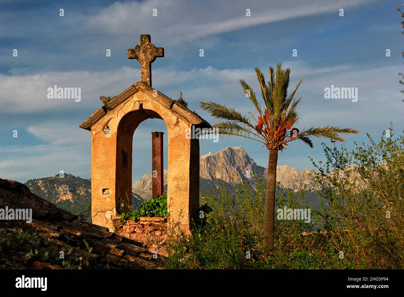 Rural chapel and palm tree with distant view of Puig Major, Mallorca, Spain Stock Photo