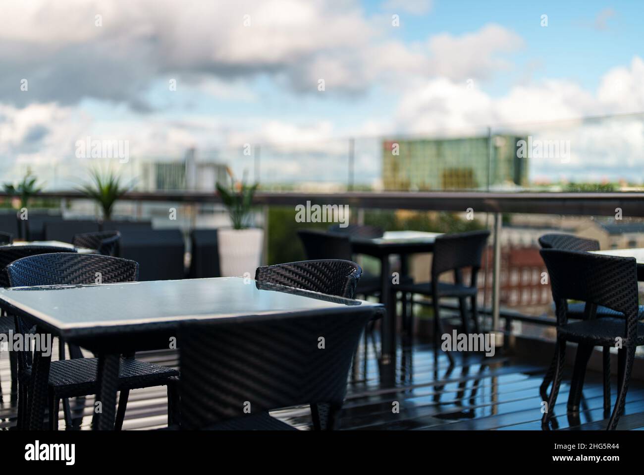 Rooftop cafe interior with table and chairs Stock Photo - Alamy