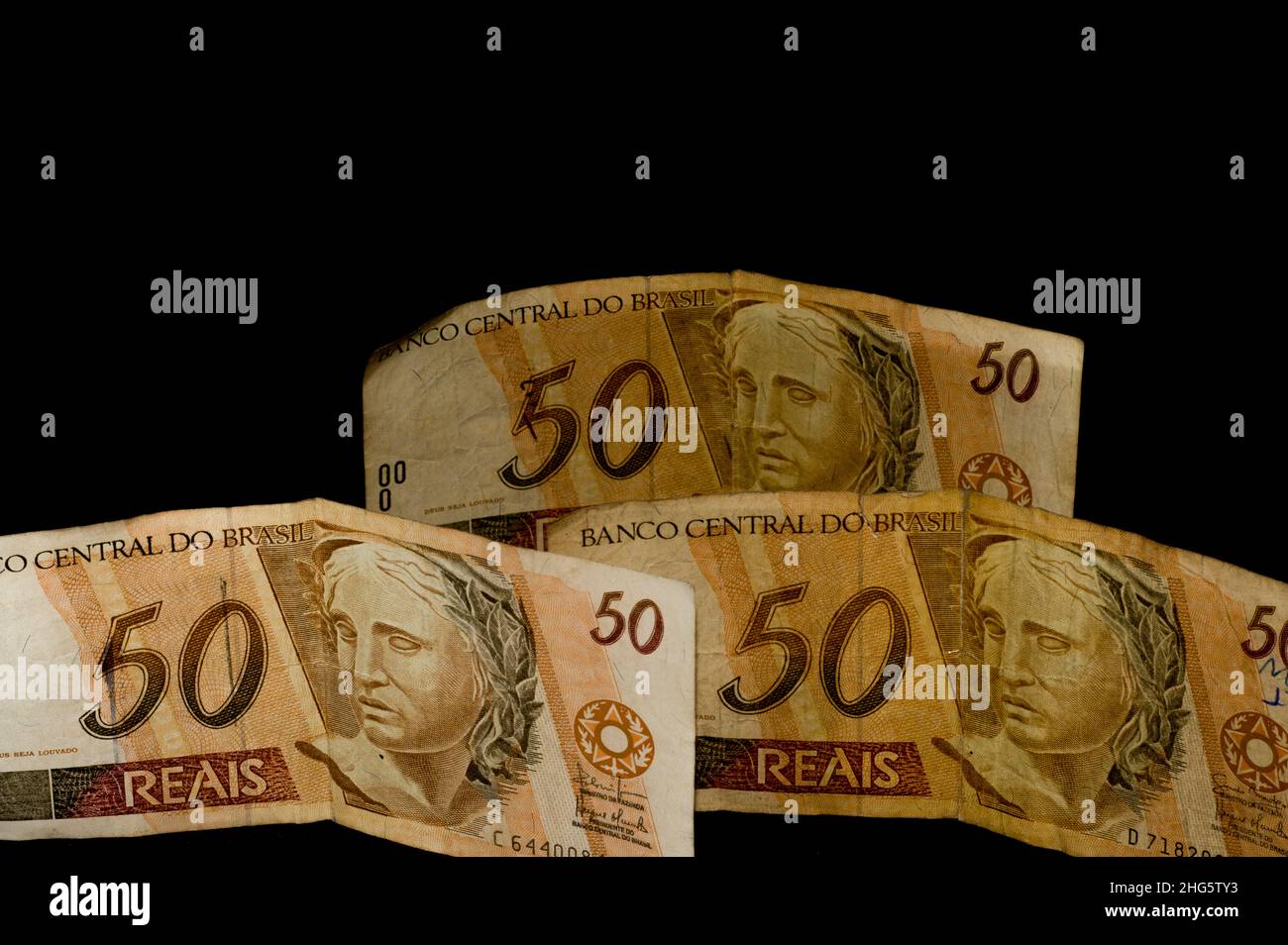 Fifty real note with hand holding, brasilian money, dark background and copy space Stock Photo