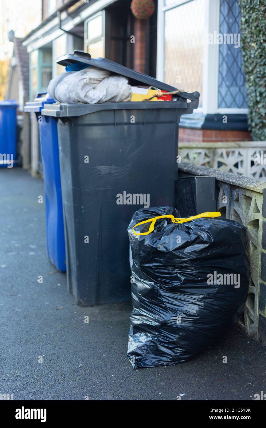 wheelie bins overflowing with household rubbish Stock Photo Alamy