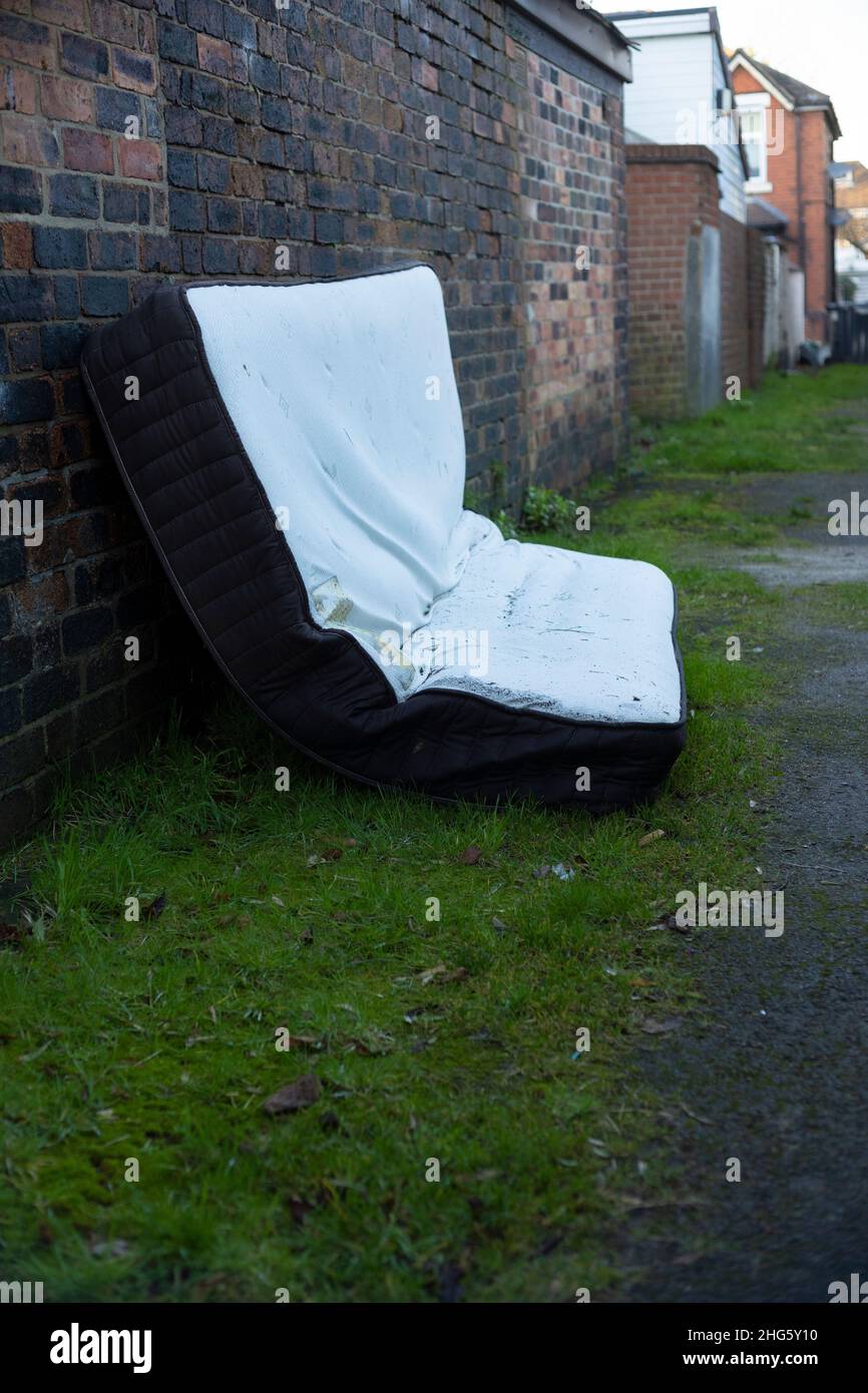 old mattress dumped up a back alley Stock Photo Alamy