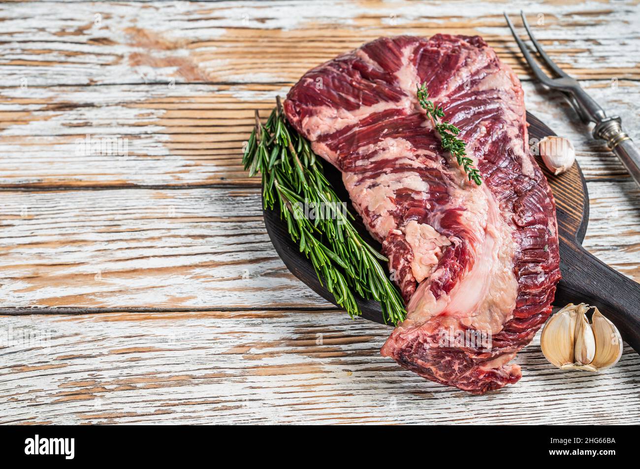 Butchers choice steak Onglet Hanging Tender beef meat on a cutting board. White wooden background. Top View. Copy space Stock Photo