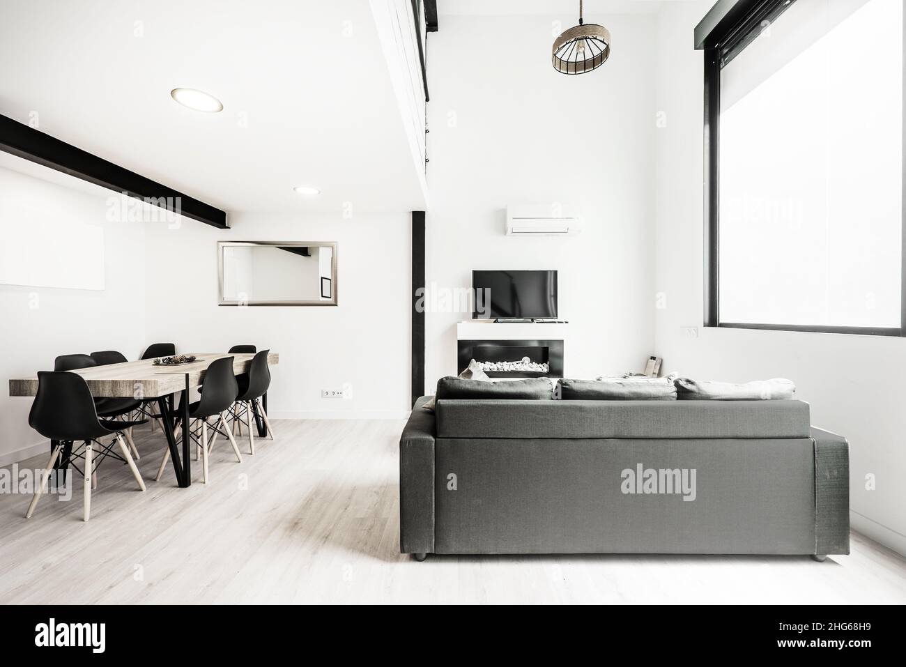 Living room with tv and dining room in a shortterm rental loft Stock