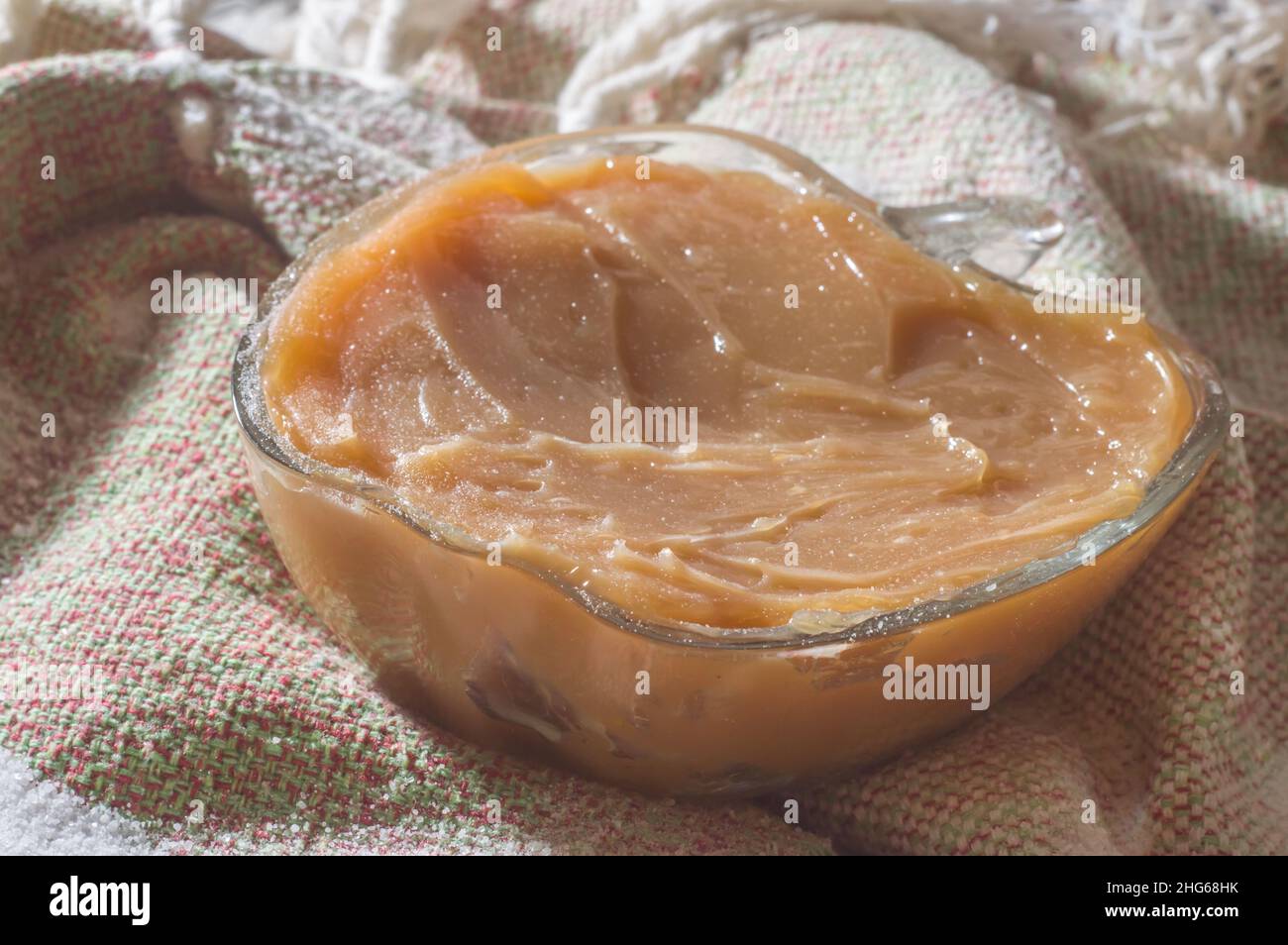 brazilian sweet called 'bolinho de chuva' rain dumpling, or Fritter, in a natural home environment copy space and hands holding a dumpling Stock Photo