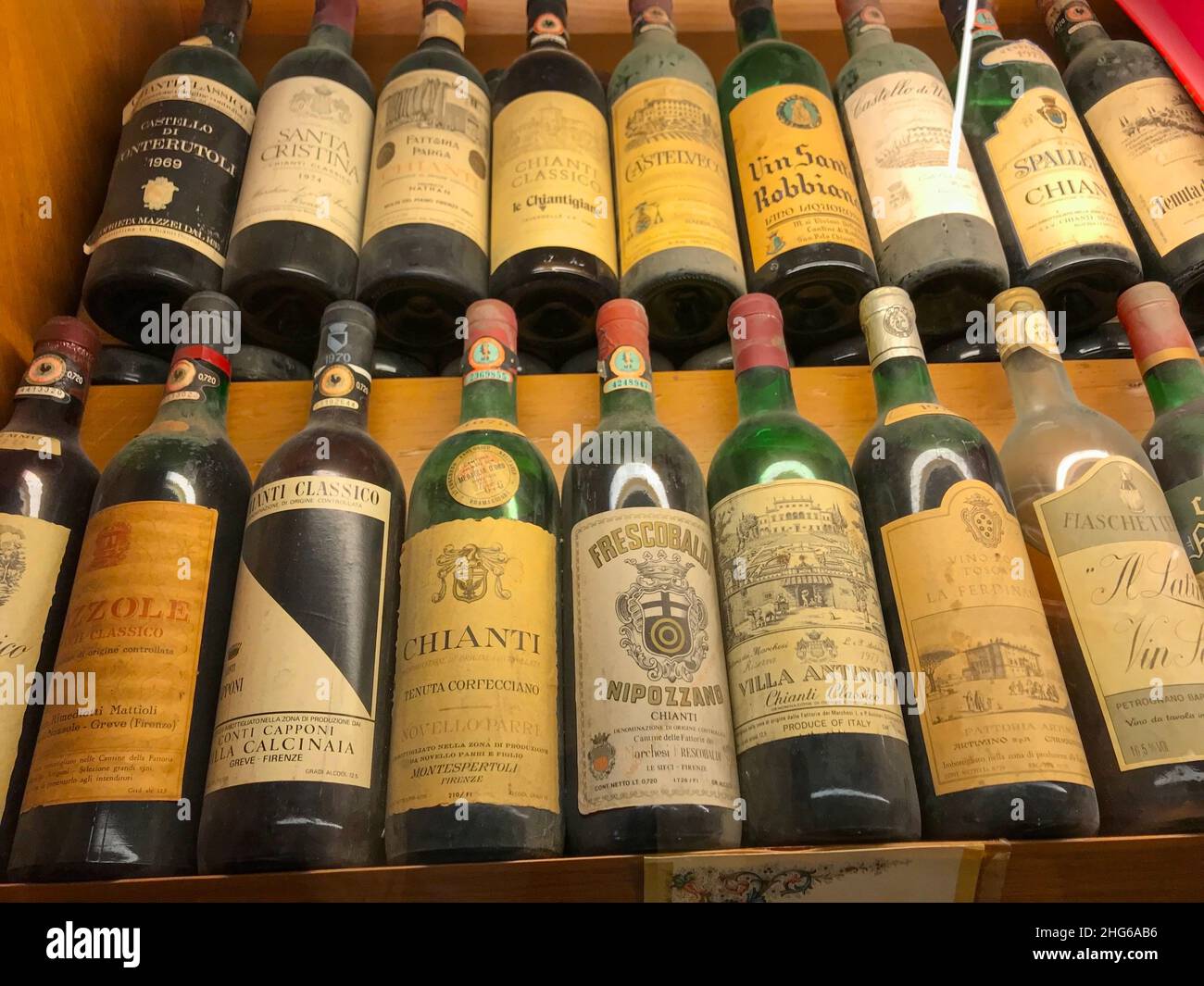 Collection of rare vintage Italian wine bottles on a shelf. Florence