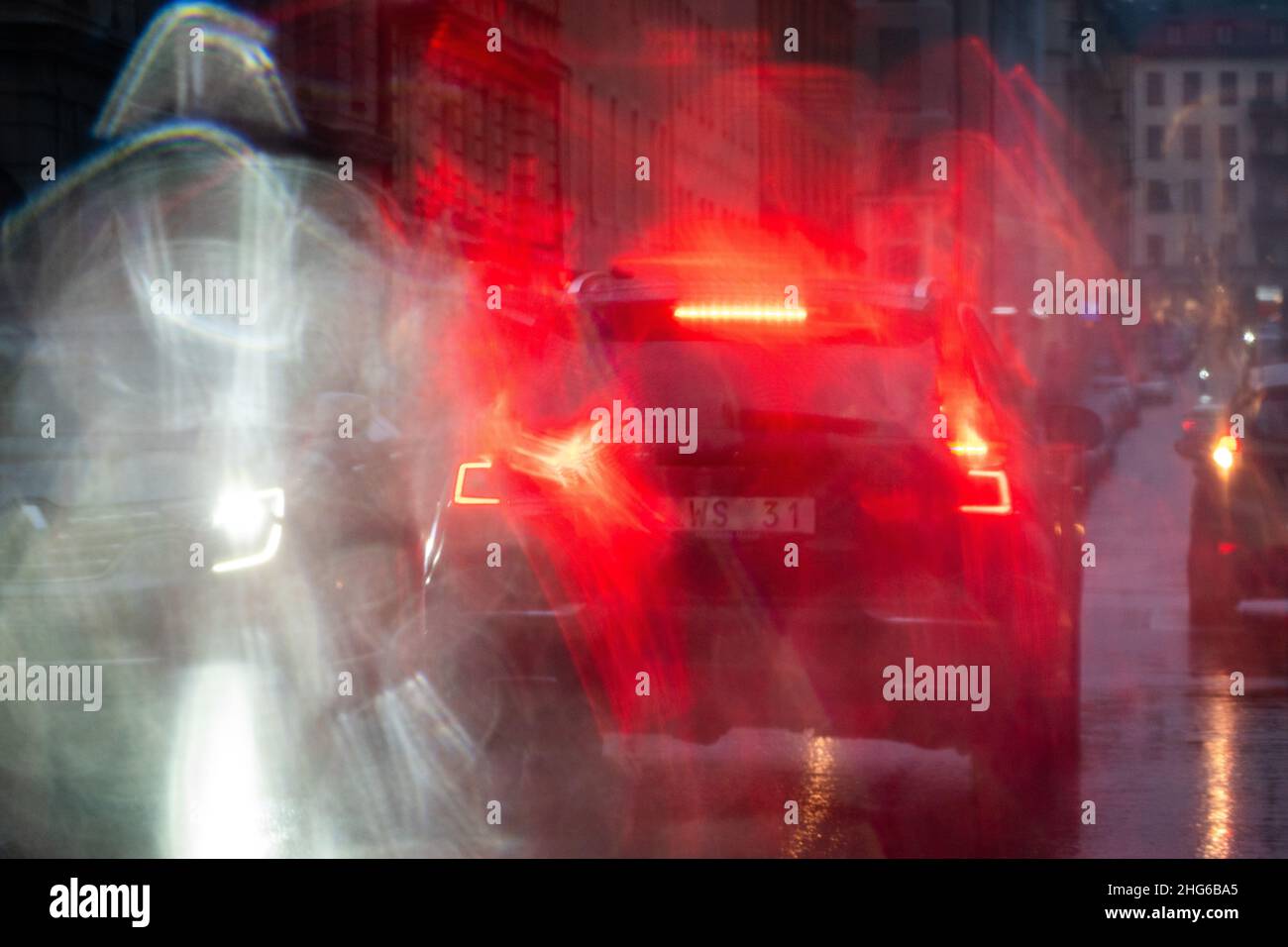 Messy traffic situations shot through rainy window Stock Photo