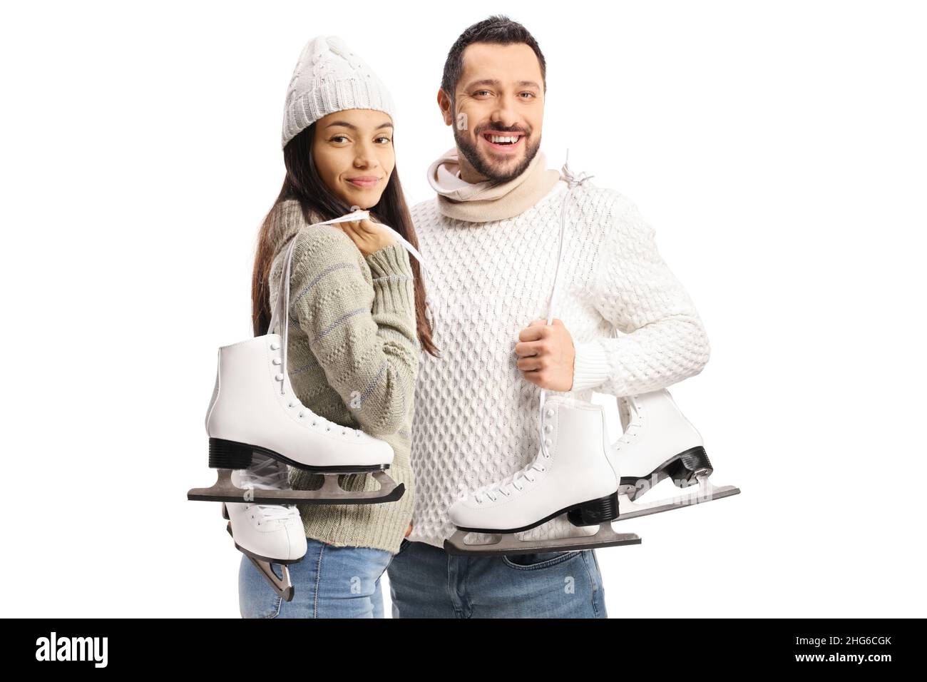 Casual young man and woman carrying iceskates on their shoulders