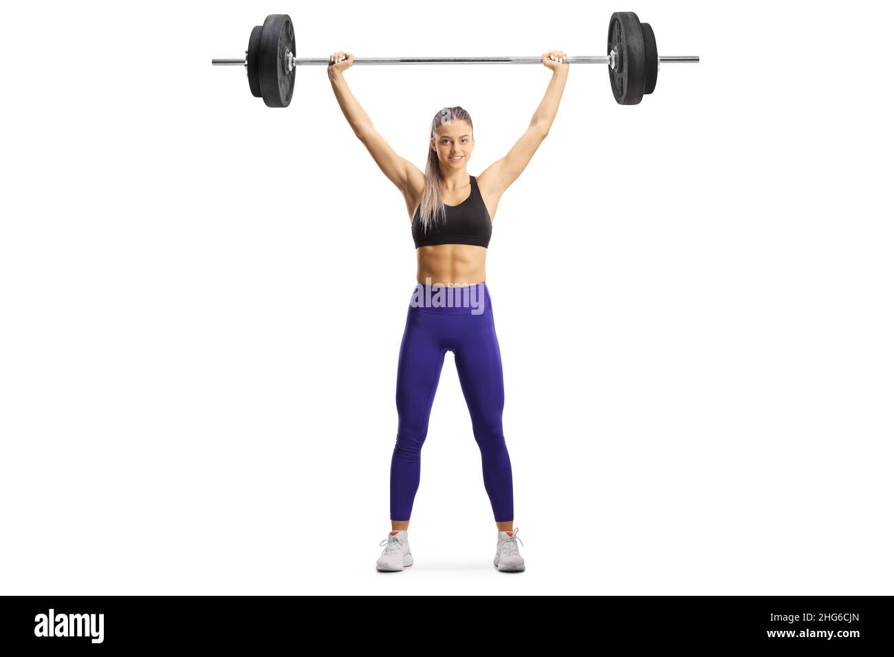 Full length portrait of a female bodybuilder standing and lifting