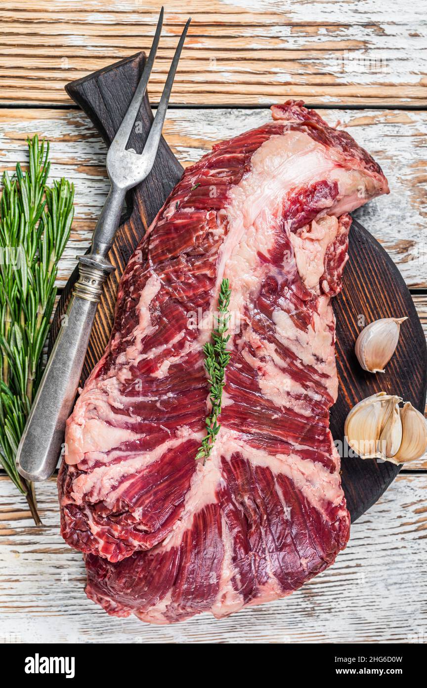 Butchers choice steak Onglet Hanging Tender beef meat on a cutting board. White wooden background. Top View Stock Photo