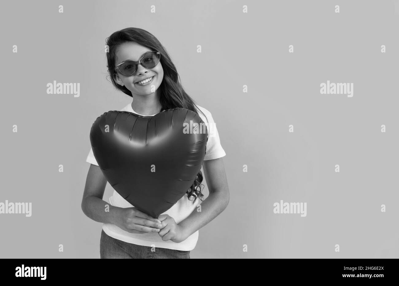 happy teen girl hold red heart party balloon for valentines day love symbol, copy space, sweetheart. Stock Photo