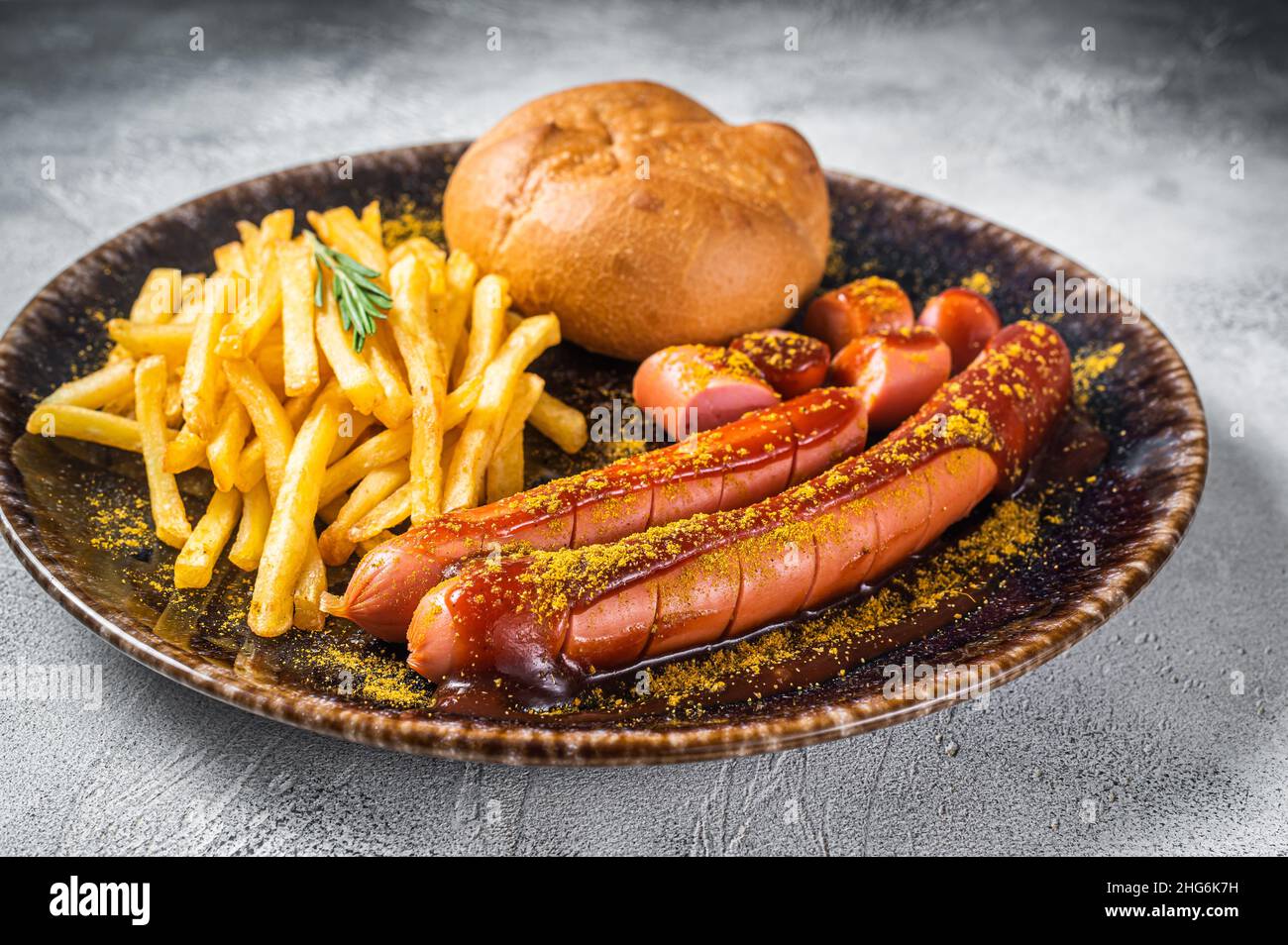 Currywurst sausages, pieces of sausage with curry sauce and French