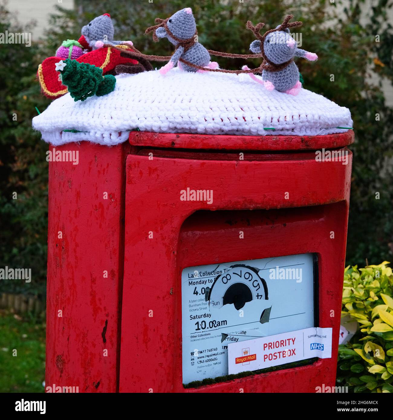 January 2022 - Knitted woollen mice as Santa and reindeer and sleigh on top of a post box in the village of Mark, Somerset, England, UK Stock Photo
